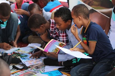 Children reading together on the classroom floor
