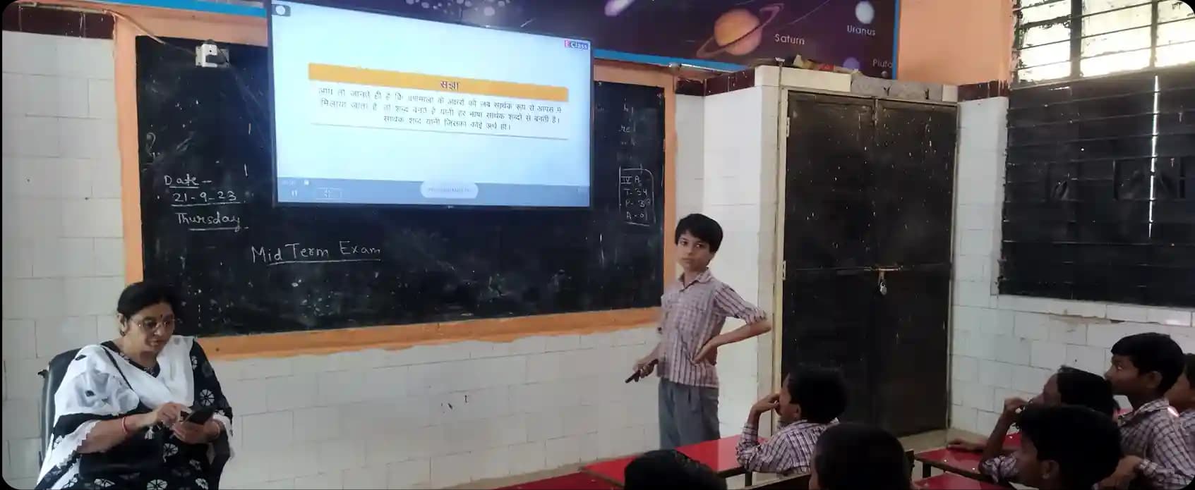 Students exploring NCERT books in Hindi on iPrep on a smart board in a Hindi medium classroom