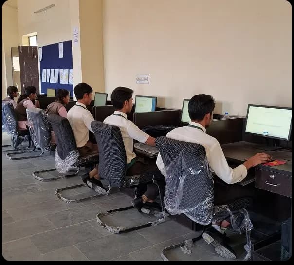Students learning on desktop computers in a school ICT lab setup