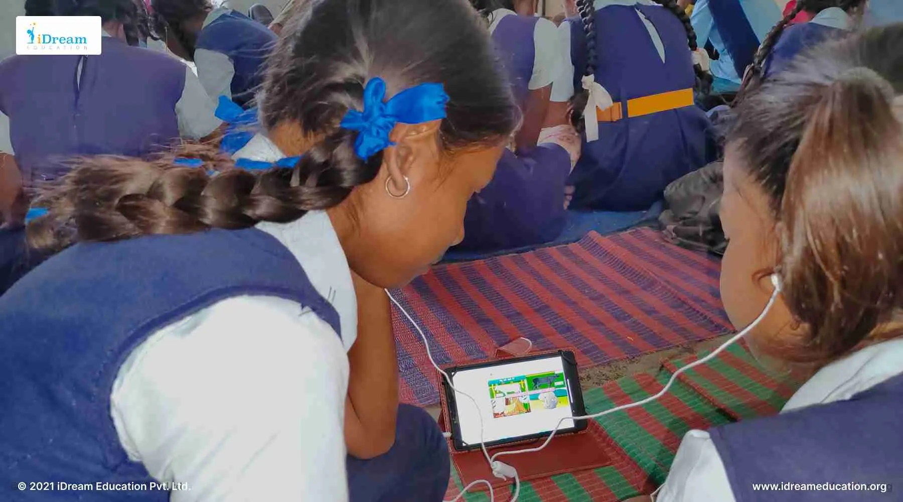 Students learning together using shared devices from an affordable digital library setup in their school