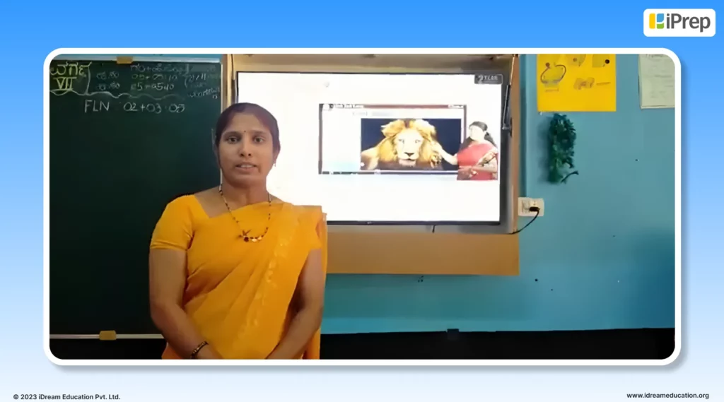 The image of a teacher appreciating our smart class solution - the iPrep Digital Clkass used for teaching and learning in rural Karnataka