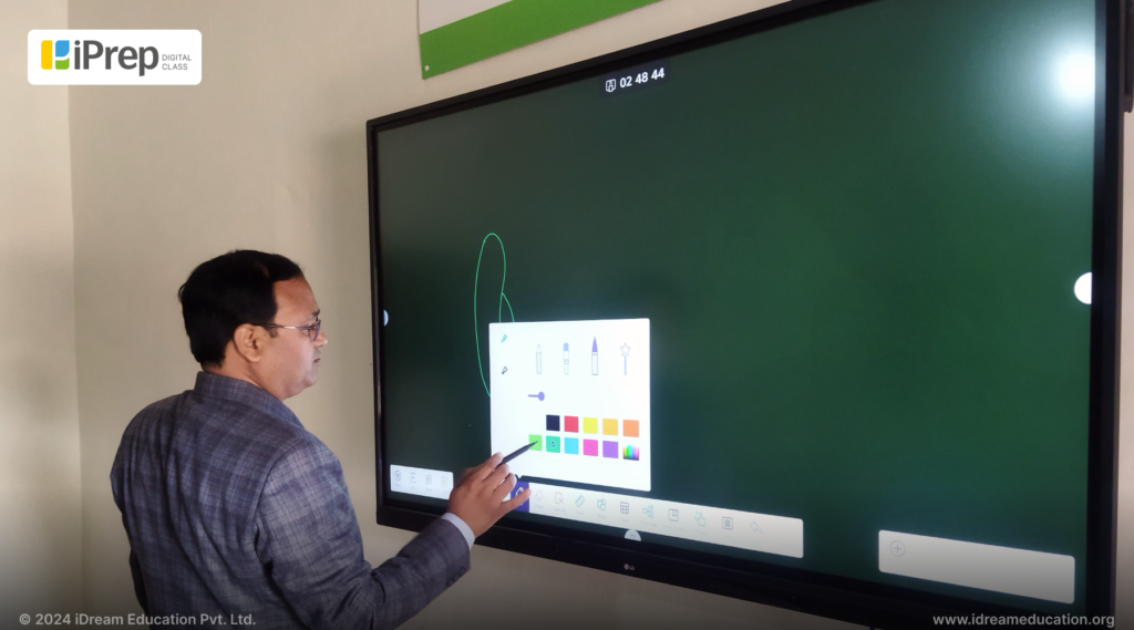 Teacher using annotation tool on an interactive flat panel, implemented in Unnao district of Uttar Pradesh.