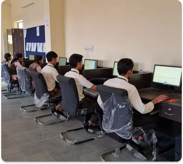 Students engaged in learning using desktop computers in a school ICT lab setup, promoting digital education through technology-enabled classrooms