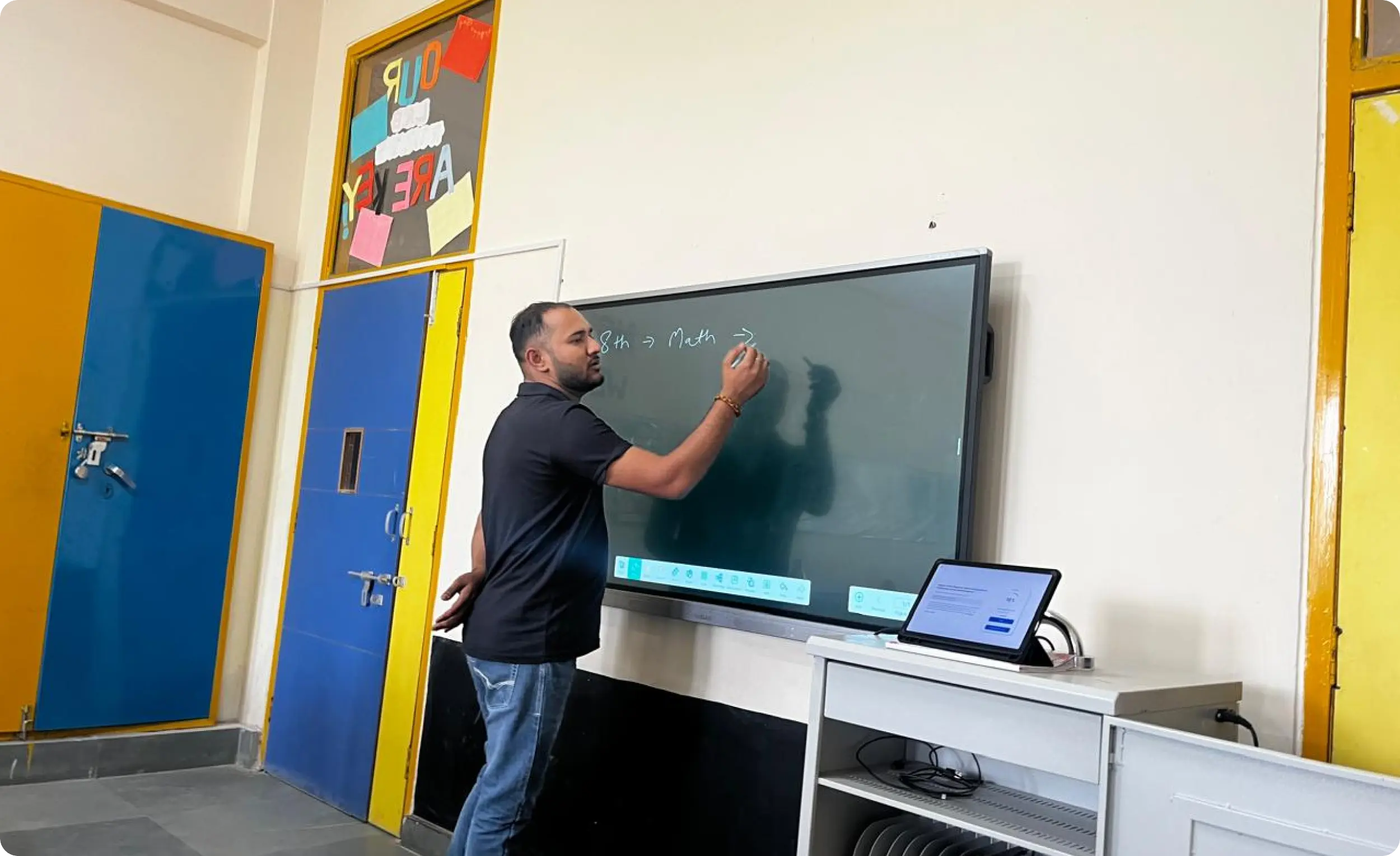 An iDream Education team member demonstrating the versatile use of a smart interactive whiteboard in a classroom setting