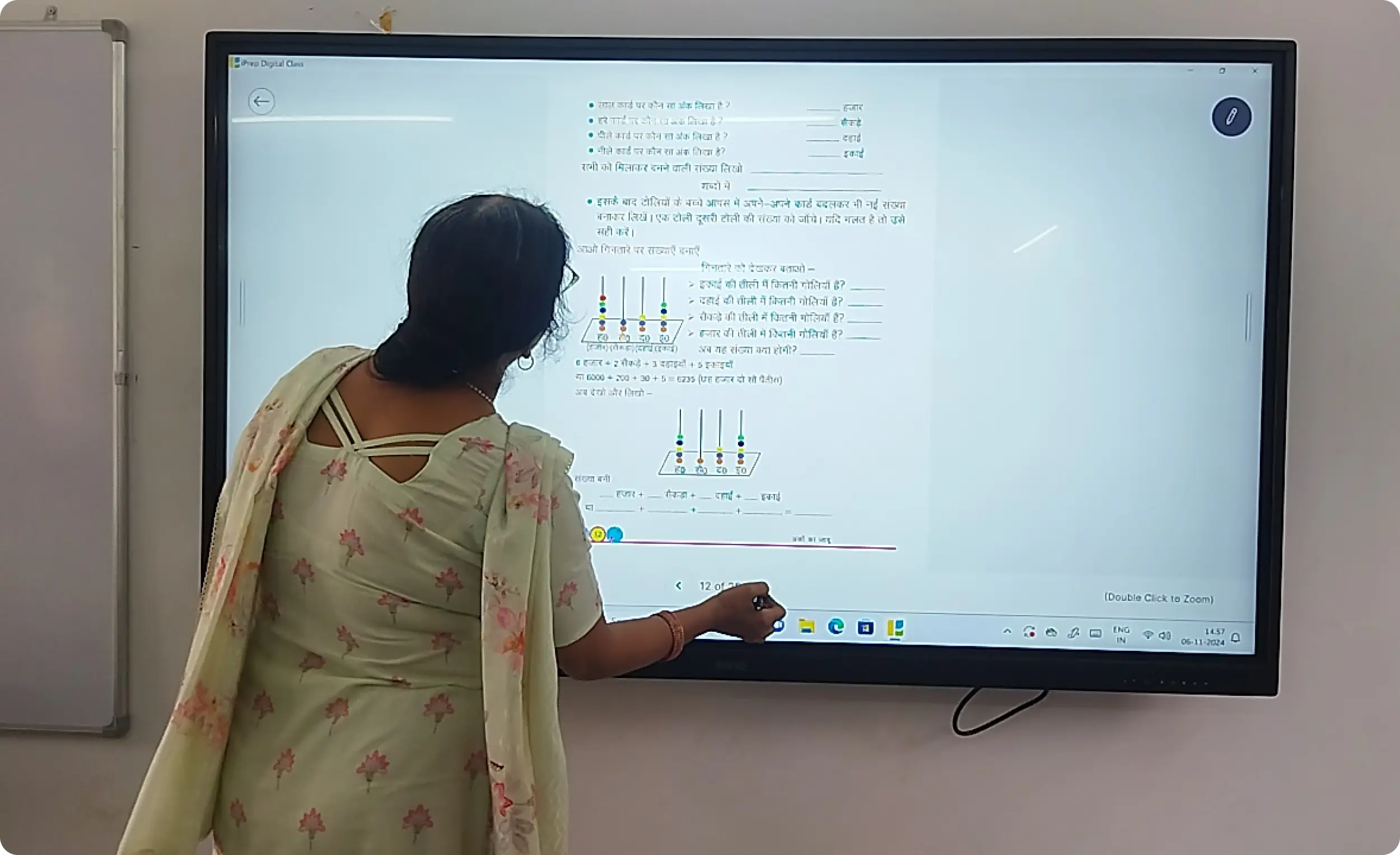 Image of a teacher scrolling digital syllabus book on one of the best digital board for teaching