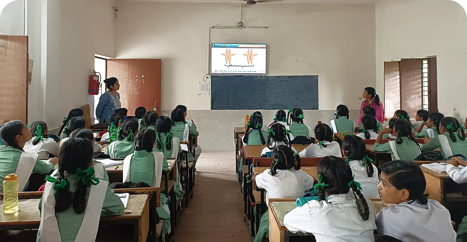 Students actively engaged with smart class content on digital screens inside a classroom setting