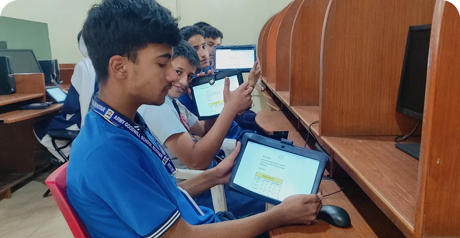 Students happily showcasing digital content on their learning tablets, which they are engaged in for personalized learning in the ICT lab of their school