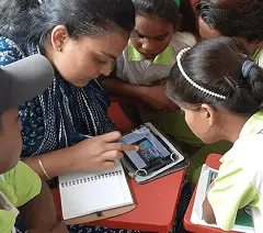 Teacher conducting a lesson using K-12 LMS and digital content on educational tablets