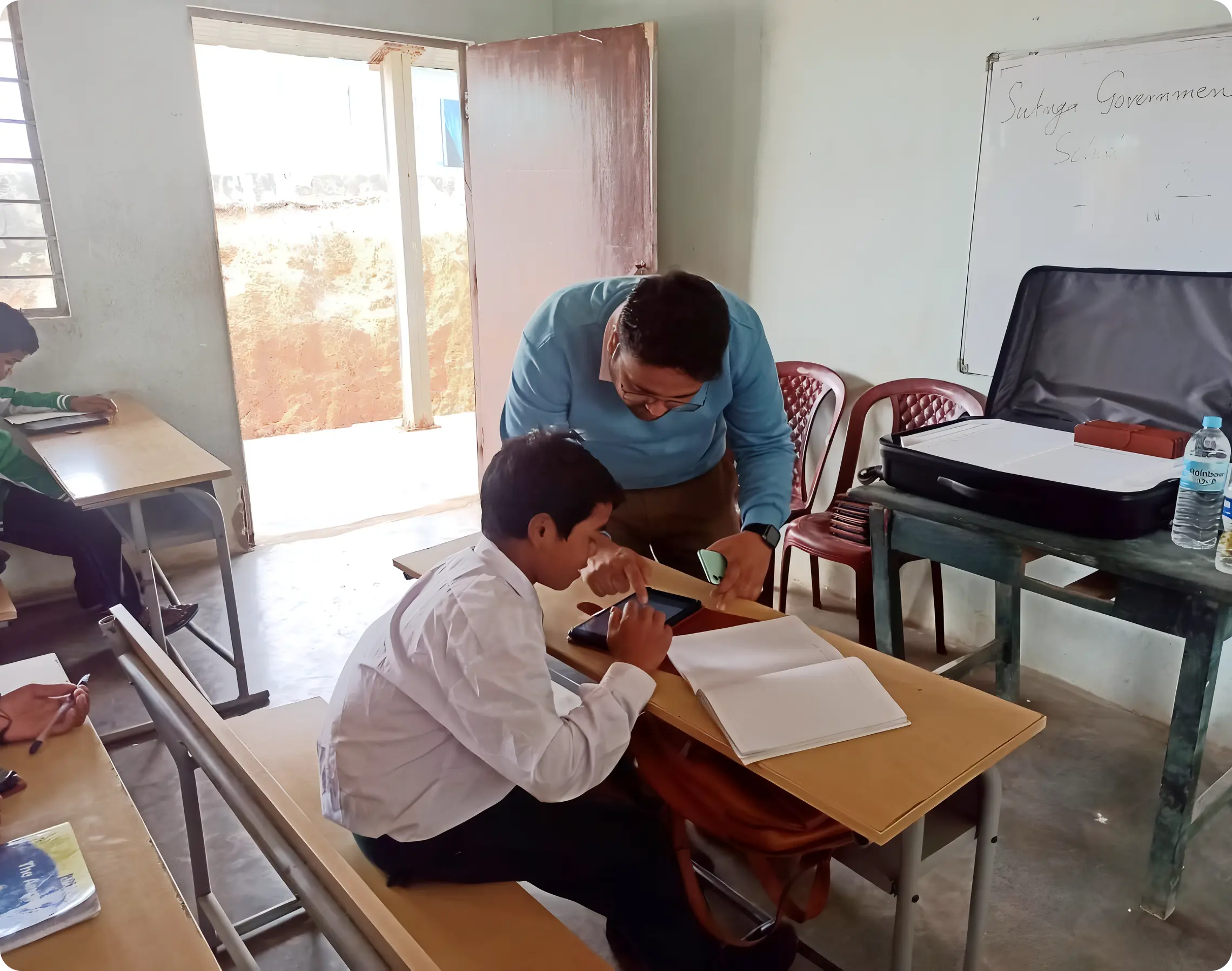 iDream Education team guiding students to take monthly assessments on tablets to evaluate their learning levels