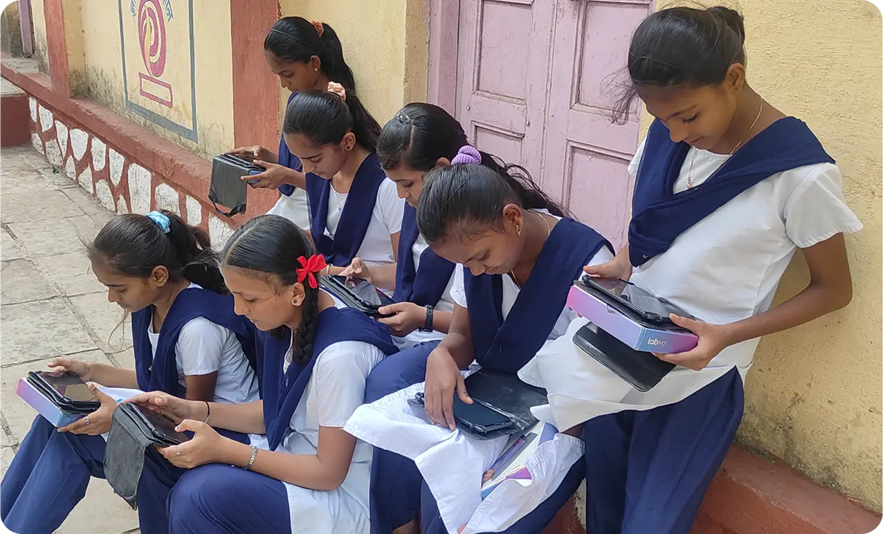 Girls attentively learning using personalised learning tablets provided by one of the leading education NGOs in India