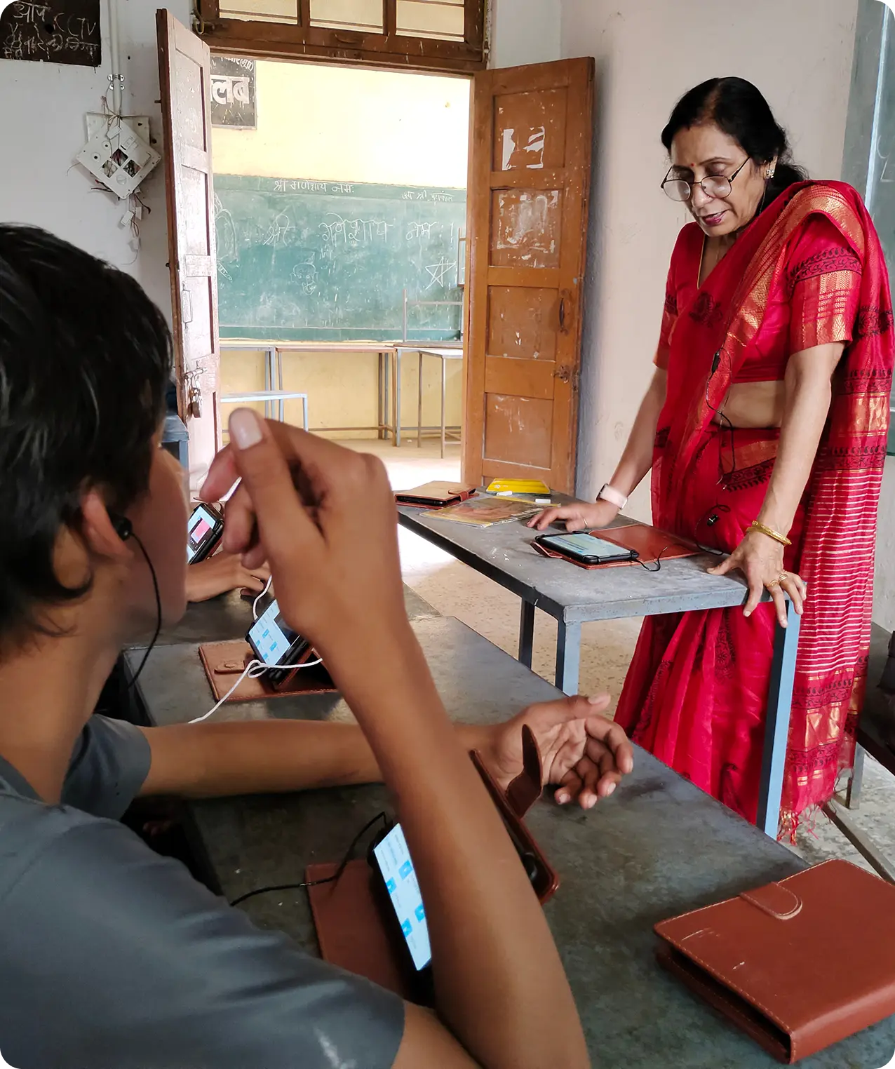 Teacher and students using tablets with offline digital content provided by an education-focused NGO