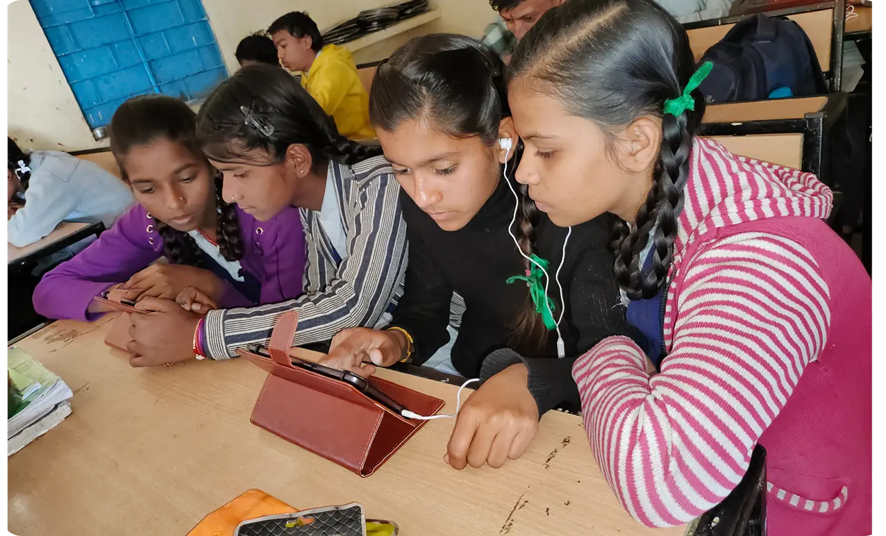 Students actively engaged with digital learning content on tablets provided by one of the top Ngos for Education