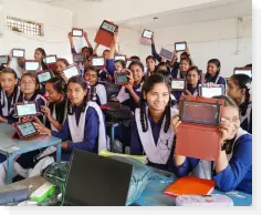 Students happily showing their personalised educational tablets provided by a digital learning NGO