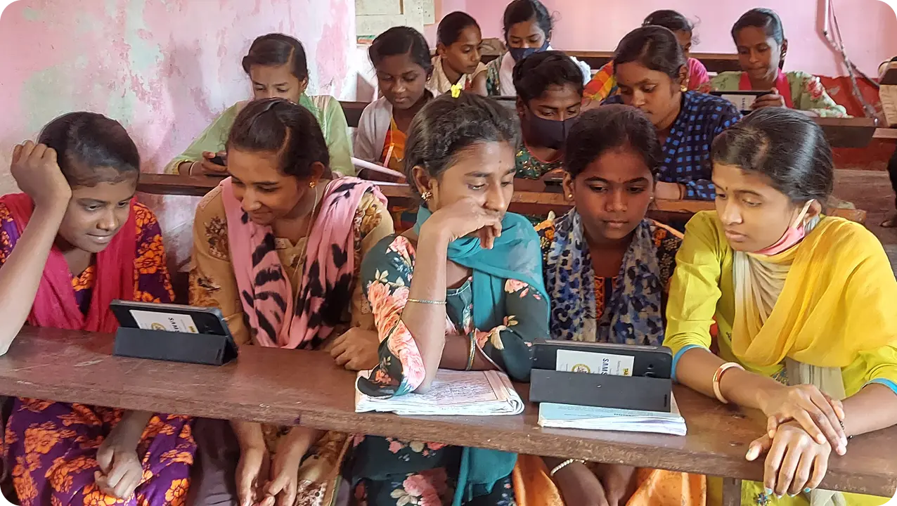 Students in a Karnataka school learning on tablets from an ICT lab setup implemented by an NGO working for CSR education initiatives