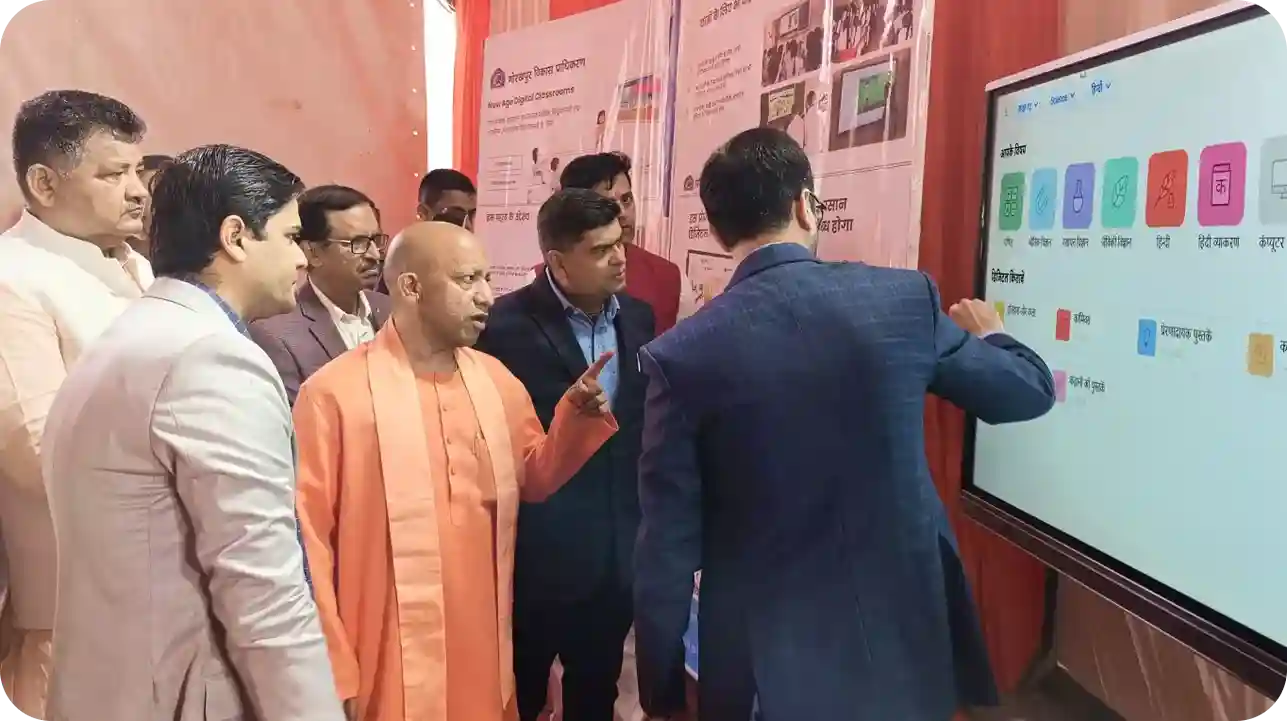 iDream Education representative presenting their smart classroom LMS for schools to Yogi at an event for Project Alankar