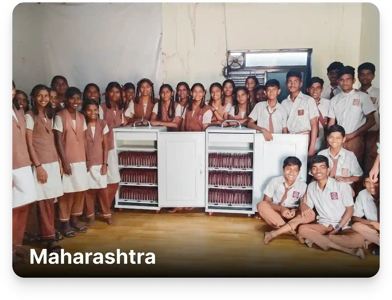 Students showing a tablet storage and charging trolley setup in a school in Maharashtra