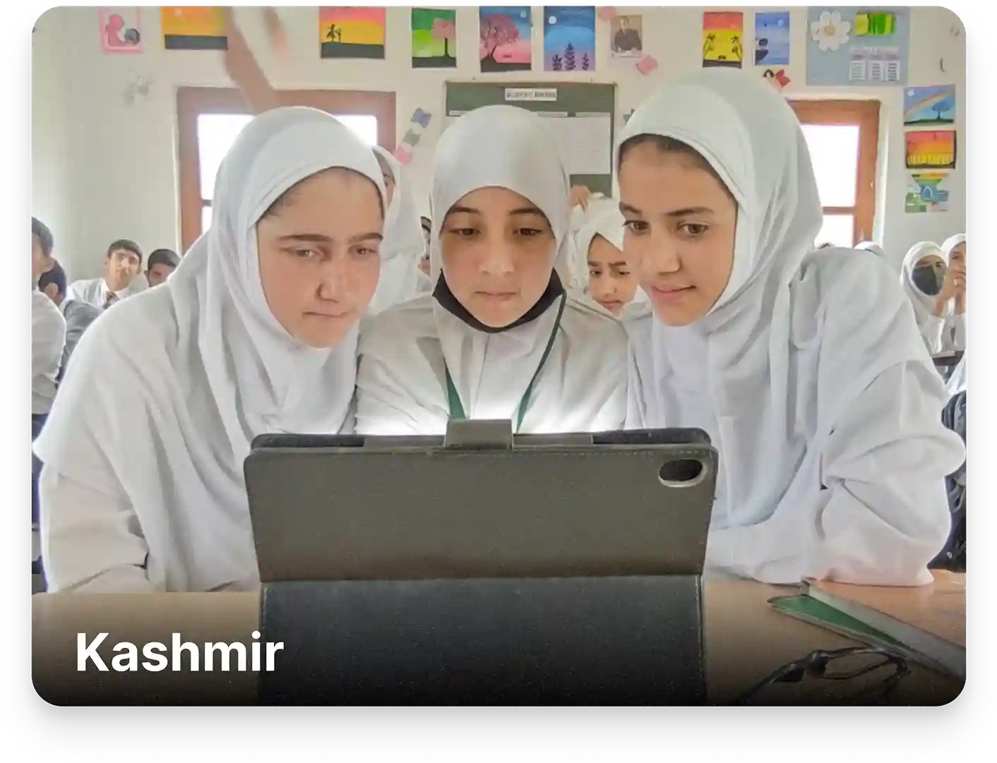 Students learning from J&K Board-aligned digital content on tablets in an ICT lab setup at a school in Kashmir