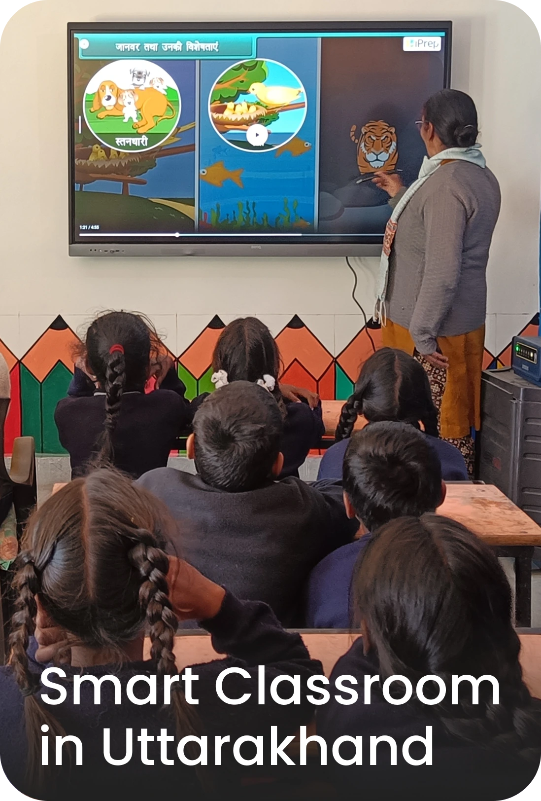 Teacher teaching through smart class content in Uttarakhand schools.