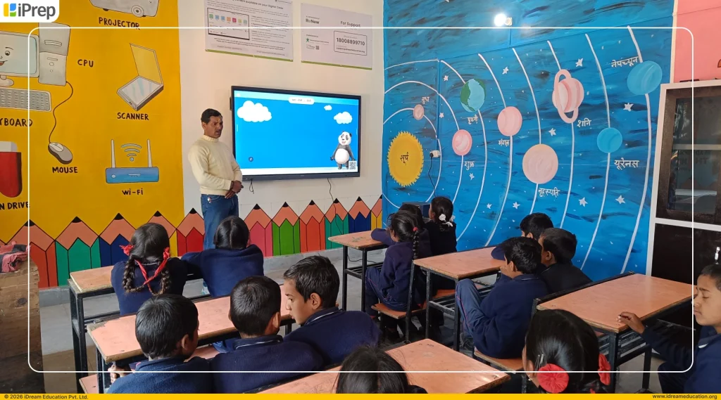 Teacher teaching through animated video content on IFP-based smart classroom setup in school.