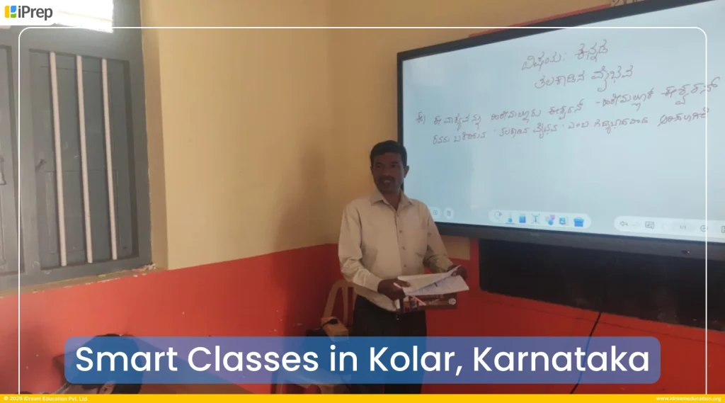 A school teacher using an interactive whiteboard for smart class teaching in Kolar government school
