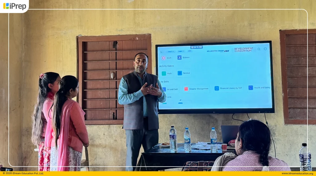 Team member conducting smart classroom training in an Assam government school.