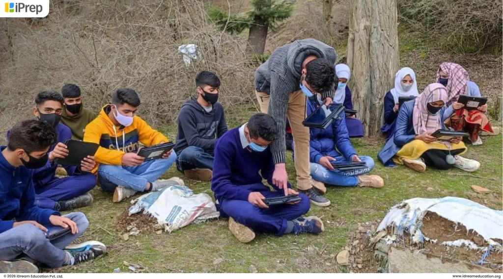 Students using tablets for digital learning outside the classroom on mountain from a ICT lab setup in school