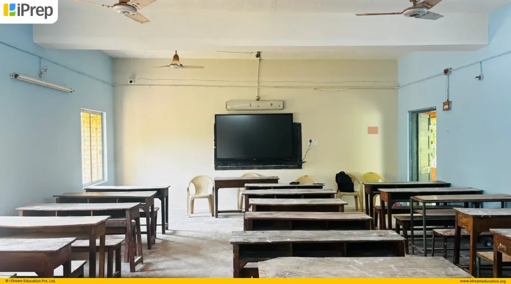 Classroom equipped with smart class hardware, including a digital display and learning setup.