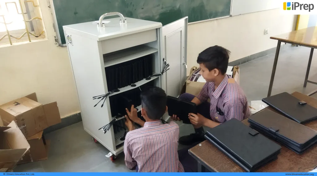 Students in a Punjab school taking PAL tablets from the PAL Lab for digital learning activities.