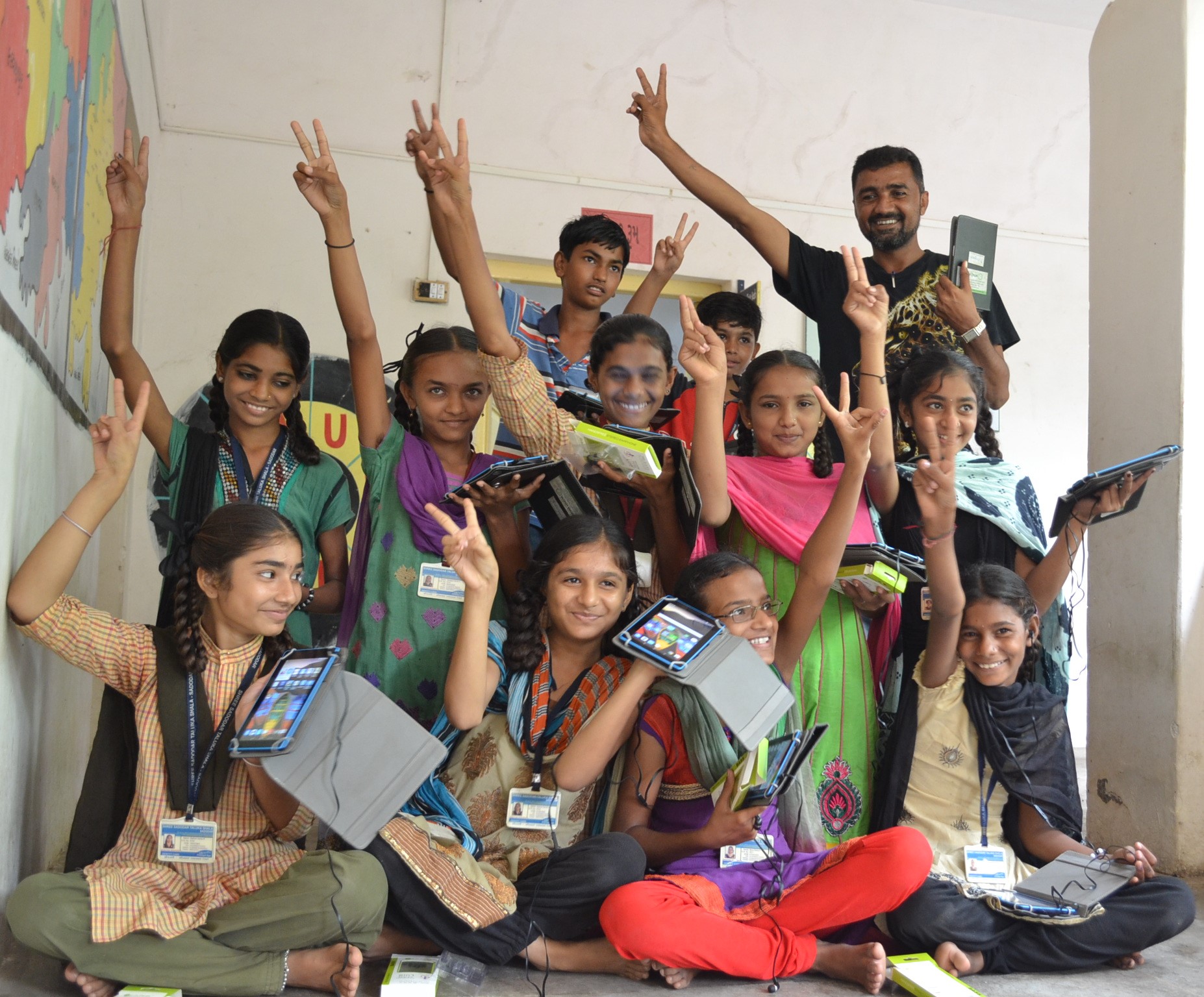 Students celebrating with tablets after training session in Gujarat